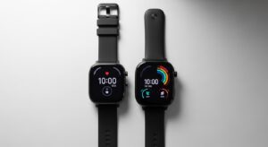 Comparison of Amazfit Bip 6 and Redmi Watch 5 side-by-side on a wooden table.
