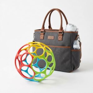 Bright Starts Oball Easy Grasp Classic Ball displayed on a white background beside a baby's diaper bag.