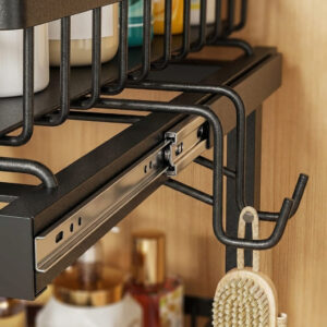 Close-up of a two-tier under-sink organizer showing its smooth sliding rails, side hanging hooks, and rust-resistant powder-coated wire frame.